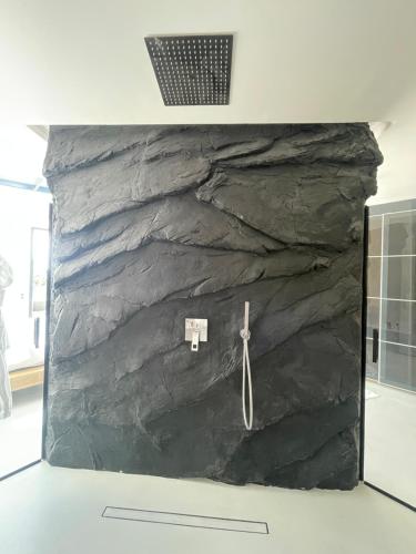 a rock wall with a pair of scissors on it at Suite impériale LOVE ROOM in Sisteron