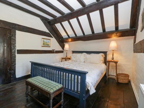 a bedroom with a blue bed in a attic at White Haywood Farmhouse in Hereford