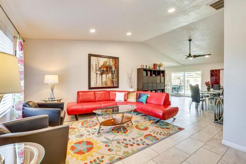 a living room with a red couch and a table at Families with Pets Welcome! Poolside Gem in Phoenix in Phoenix