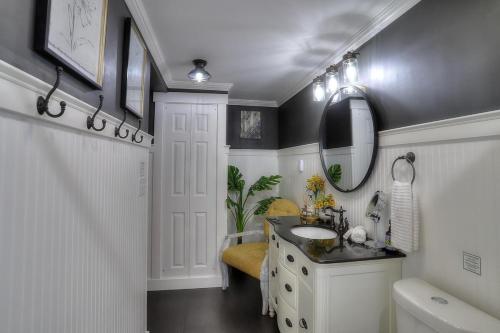 a bathroom with a sink and a mirror at Beautiful Spacious & Well-Stocked Downtown Home in Rangeley