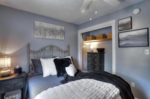 a blue bedroom with a bed and a dresser and a bed sidx sidx sidx at Beautiful Spacious & Well-Stocked Downtown Home in Rangeley