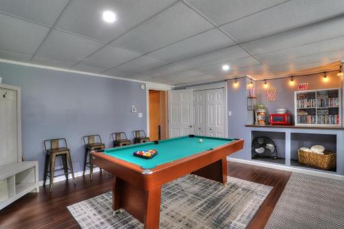a living room with a pool table in it at Beautiful Spacious & Well-Stocked Downtown Home in Rangeley