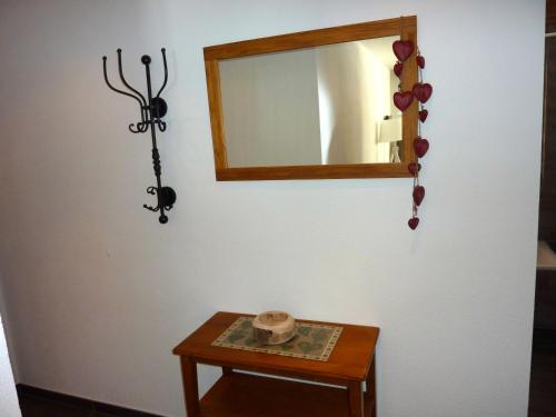 a mirror on a wall next to a table at Hotel Mont.Lac in Champex