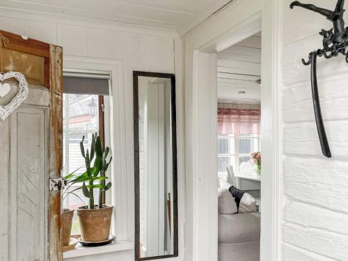 a hallway with a mirror and a potted plant at 4 star holiday home in Märsta in Märsta