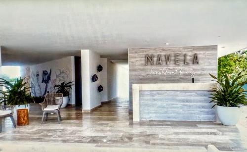 a lobby with a sign that reads navalia with plants at Penthouse Navela 405 Beachfront in Telchac Puerto