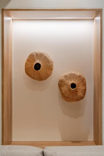 two baskets are on a wall in a room at Casa Myrtēssa in Myrtos