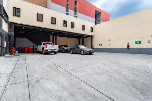 a garage with cars parked inside of a building at Hotel Flamencos Centro Histórico in Mexico City