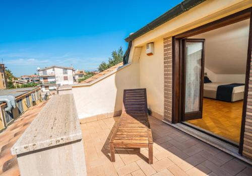 a bench sitting on the balcony of a house at Villa Antonella Wellness & Jacuzzi in Ciampino