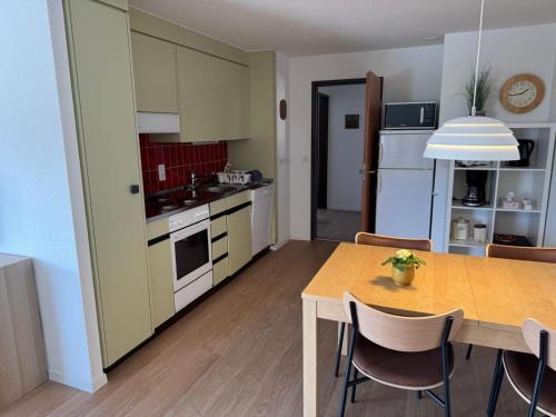 a kitchen and dining room with a table and chairs at Jizerka in Unterwasser