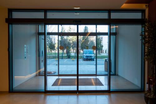 an open glass door of a building at Planet Residence-Studio Solis in Niš