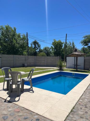 a patio with two chairs and a swimming pool at casa de un ambiente in Funes