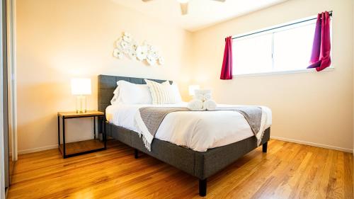 a bedroom with a large bed and a window at Dreamy Lux Heated Pool SPA 3BR in Urban Campbell in Campbell
