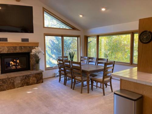 a dining room with a table and a fireplace at Sunny Vail Mountainside Getaway Amazing Location in Vail