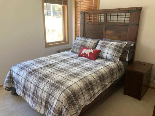 a bedroom with a bed with a red pillow on it at Sunny Vail Mountainside Getaway Amazing Location in Vail
