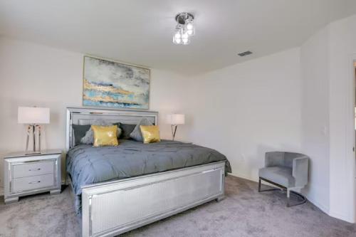 a bedroom with a bed with yellow pillows and a chair at Sunset Harem Hideaway Port St Lucie in Port Saint Lucie