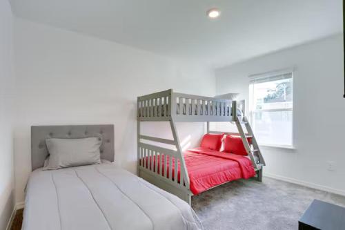 a bedroom with a bunk bed with red pillows at Sunset Harem Hideaway Port St Lucie in Port Saint Lucie