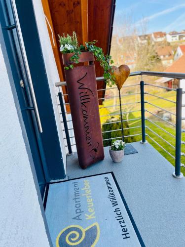 a vase sitting on a porch with a plant at Apartment Keuerleber in Holzmaden