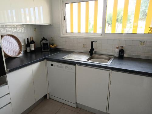 a kitchen with a sink and a counter top at Villa Blue - Aldeia do Golfe in Quarteira