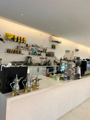 a large kitchen with a counter with many appliances at فندق حياة حقل الفندقية Hayat Haql Hotel in Al Humaizah