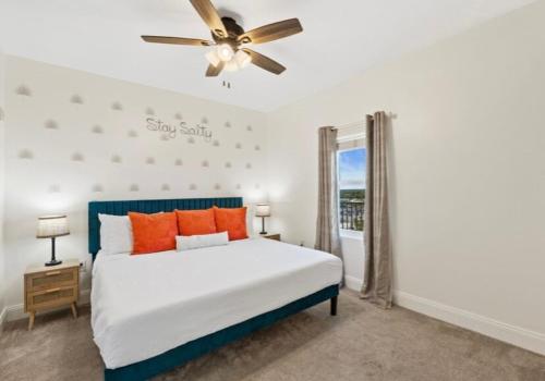 a bedroom with a bed and a ceiling fan at BeachFrnt 2 Hottub 5 Pools Jet Ski in Panama City Beach