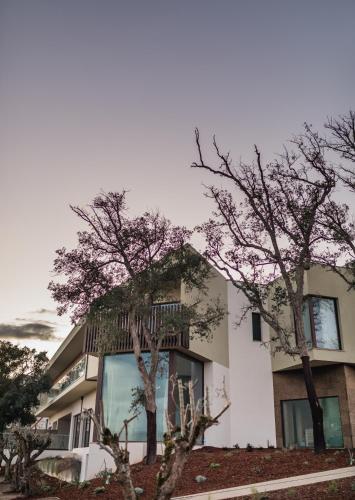 a building with trees in front of it at Haven Nature Hotel & Villas in Batalha