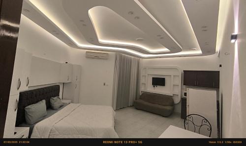 a bedroom with a bed and a couch and a tv at Paradise Hill in Hurghada