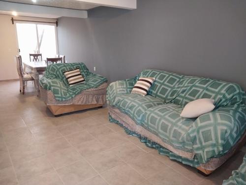 a living room with a couch and a chair at Family Cutting House in Xalostoc