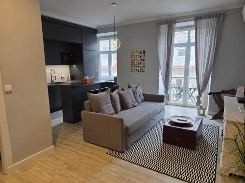 a living room with a couch and a kitchen at My Lisbon Story in Lisbon