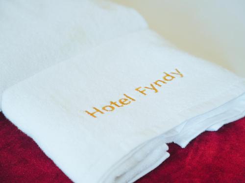a white napkin with the words happy harvest written on it at Fyndy Hotel Dakhla in Dakhla