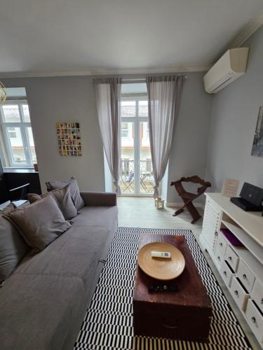 a living room with a couch and a table at My Lisbon Story in Lisbon