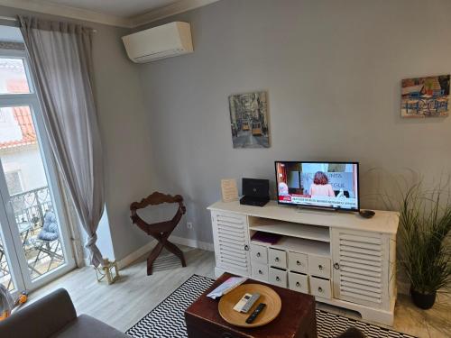 a living room with a tv on a white cabinet at My Lisbon Story in Lisbon