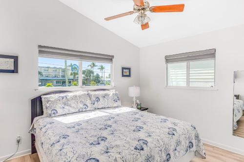 a bedroom with a bed and a ceiling fan at Ocean Oasis III in Key Colony Beach
