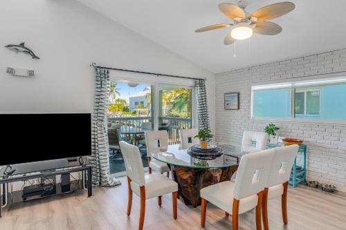 a dining room with a tv and a table and chairs at Ocean Oasis III in Key Colony Beach