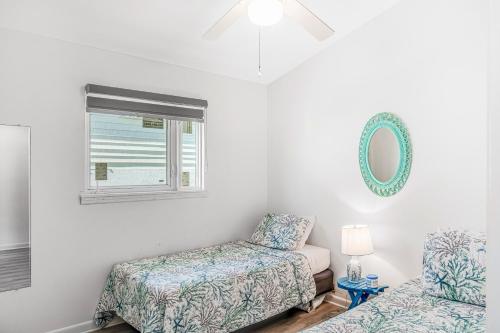 a bedroom with two beds and a window at Ocean Oasis III in Key Colony Beach