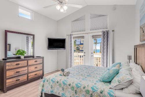 a bedroom with a bed and a dresser and a mirror at Ocean Oasis III in Key Colony Beach
