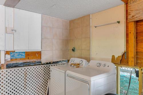 a kitchen with a white washing machine in it at Ocean Oasis III in Key Colony Beach