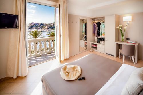 a hotel room with a bed and a large window at Hotel Vesuvio in Rapallo