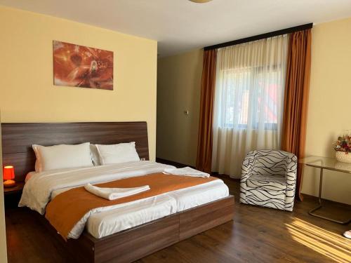 a bedroom with a large bed and a window at Pietrele Doamnei in Pojorîta