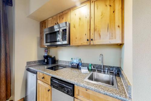 a kitchen with a sink and a microwave at Grand Lodge #151 in Crested Butte