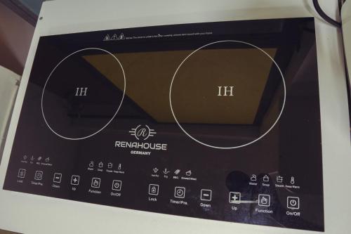 a microwave oven with its dials and controls at Laureles Garden Hostel in Medellín