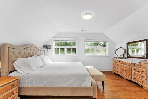 a bedroom with a bed and a dresser and a mirror at Private 2bdrm unit with ensuite Laundry - U5A in Burlington