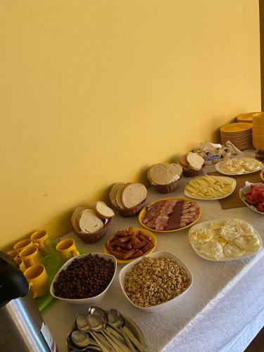 a table topped with lots of different types of food at Pietrele Doamnei in Pojorîta