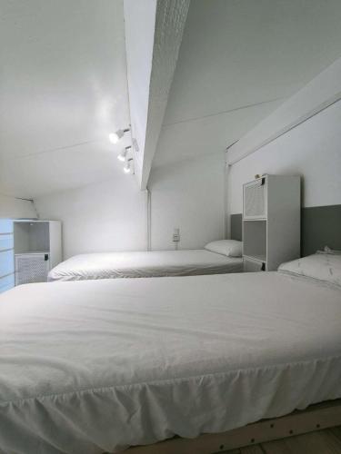 - une chambre blanche avec 2 lits dans l'établissement Résidence Palmyra - T2 mezzanine - 6 personnes - clim en option - piscine inclus MAE-5774, au Barcarès