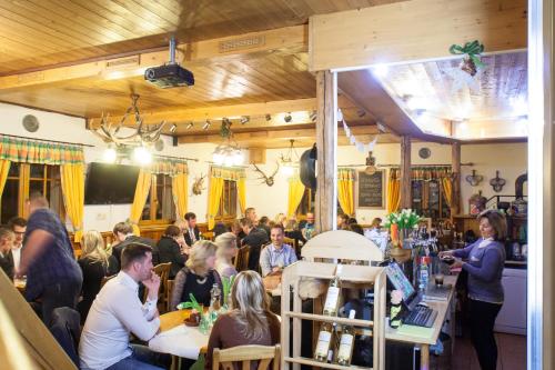 a crowd of people sitting at tables in a restaurant at Penzion Alenka in Špindlerův Mlýn