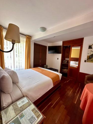 Ένα ή περισσότερα κρεβάτια σε δωμάτιο στο Hotel Mabey Urubamba