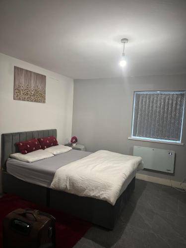 a bedroom with a bed and a window at Home sweet home in Leicester