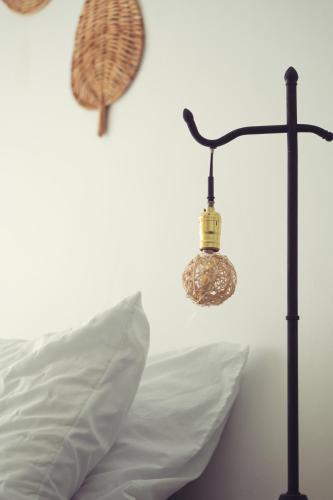 a lamp next to a pillow next to a bed at Laureles Garden Hostel in Medellín