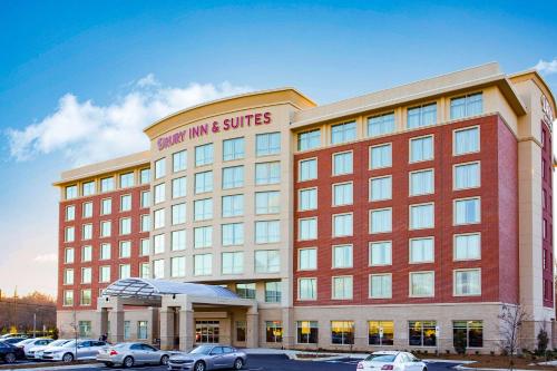 a large building with cars parked in a parking lot at Drury Inn & Suites Charlotte Arrowood in Charlotte