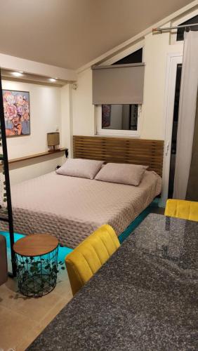 a bedroom with a large bed and a table at Vivere Terrace Seaside Kalamata in Faraí