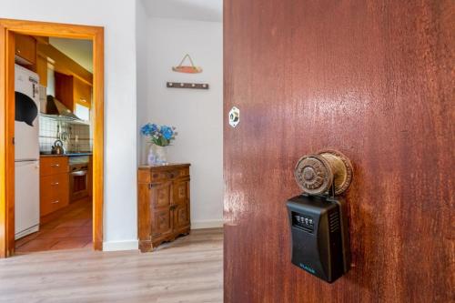 a door to a kitchen with a small microwave at Beautiful flat in Castelldefels in Castelldefels